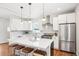 Modern kitchen with a large island, stainless steel appliances, and sleek white cabinetry at 4603 W 33Rd Ave, Denver, CO 80212