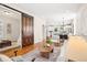 Spacious living area featuring hardwood floors, a sliding barn door, and an open layout connecting the dining and kitchen at 4603 W 33Rd Ave, Denver, CO 80212