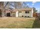 Backyard view of house, large tree, and detached shed at 4825 Estes St, Arvada, CO 80002