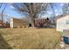 Large backyard with mature trees and a detached shed at 4825 Estes St, Arvada, CO 80002