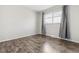 Inviting bedroom showcasing wood floors, neutral walls, and a window with privacy blinds at 4825 Estes St, Arvada, CO 80002
