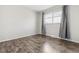 Bright bedroom with wood-look flooring and grey curtains at 4825 Estes St, Arvada, CO 80002