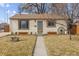 House exterior featuring a walkway and well-maintained lawn at 4825 Estes St, Arvada, CO 80002