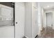 Hallway featuring a stacked washer/dryer and additional storage cabinets at 4825 Estes St, Arvada, CO 80002