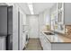 Updated kitchen features white cabinetry, modern appliances, and sleek countertops, offering a stylish cooking space at 4825 Estes St, Arvada, CO 80002
