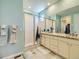 Main bathroom with double vanity, granite counters and tiled shower at 15347 Quince Cir, Thornton, CO 80602