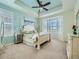 Spacious bedroom with tray ceiling, ceiling fan, bay window and neutral carpet at 15347 Quince Cir, Thornton, CO 80602