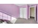 Bright bedroom with light purple walls and carpet at 5556 Flanders Way, Denver, CO 80249