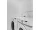 Laundry room with white washer and dryer at 5556 Flanders Way, Denver, CO 80249