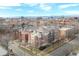 Bird's-eye view showcasing a residential building with a red-brick courtyard and a panoramic city skyline at 1699 N Downing St # 409, Denver, CO 80218