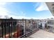 Balcony with metal railing offering views of the surrounding neighborhood and a clear blue sky above at 1699 N Downing St # 409, Denver, CO 80218