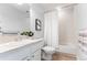 Bright bathroom featuring a shower-tub combo, white fixtures, a neutral color palette, and a decorative plant at 1699 N Downing St # 409, Denver, CO 80218