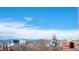 Scenic city view featuring the Denver skyline, a church spire, and the majestic Rocky Mountains in the background at 1699 N Downing St # 409, Denver, CO 80218