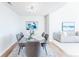 Dining room featuring a modern glass table and views into the living room at 1699 N Downing St # 409, Denver, CO 80218