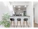 Bright wet bar with barstool seating and views into the kitchen at 1699 N Downing St # 409, Denver, CO 80218