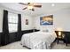 Cozy bedroom featuring a ceiling fan, wainscotting, a large window, and neutral decor at 9770 Quitman Way, Westminster, CO 80031