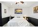 This bedroom features black lower walls, neutral paint, a ceiling fan, and skyline art above the bed at 9770 Quitman Way, Westminster, CO 80031