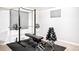 Basement gym with weight rack, bench press, dumbbells, and rubber mat flooring at 9770 Quitman Way, Westminster, CO 80031