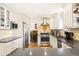 Bright kitchen featuring granite countertops, stainless steel appliances, and white cabinetry at 9770 Quitman Way, Westminster, CO 80031