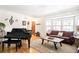 Inviting living room featuring a grand piano and ample natural light at 9770 Quitman Way, Westminster, CO 80031