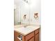 Bathroom vanity features a sink, faucet, wood cabinetry, and a large mirror for a bright, functional space at 633 W 114Th Way, Northglenn, CO 80234