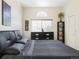 Comfortable bedroom with a gray bed set, a window, and a black wooden dresser at 633 W 114Th Way, Northglenn, CO 80234
