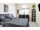 Comfortable bedroom with a gray bed set, a window, and a black wooden dresser at 633 W 114Th Way, Northglenn, CO 80234