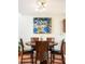 Warm dining area featuring a wooden table, modern light fixture, and neutral wall decor at 633 W 114Th Way, Northglenn, CO 80234