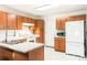 Functional kitchen featuring ample cabinet space, white appliances, and a peninsula sink at 633 W 114Th Way, Northglenn, CO 80234
