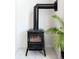 Modern wood burning stove with black metallic finish and sleek ducting at 633 W 114Th Way, Northglenn, CO 80234