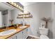 Bright bathroom with double sinks, butcher block counters and tasteful decor at 6001 Castlegate Dr # A33, Castle Rock, CO 80108