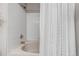 Clean bathroom with a tub and shower combination, featuring neutral tile and a white shower curtain at 6001 Castlegate Dr # A33, Castle Rock, CO 80108