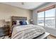 Comfortable bedroom with a large window and a view, featuring neutral colors and soft bedding at 6001 Castlegate Dr # A33, Castle Rock, CO 80108