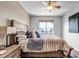 Comfortable bedroom with a ceiling fan and natural light, featuring soft bedding and a serene atmosphere at 6001 Castlegate Dr # A33, Castle Rock, CO 80108