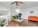 Open bonus room featuring a work desk, bright orange couch and stairs to a second level at 6001 Castlegate Dr # A33, Castle Rock, CO 80108
