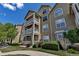 Multi-story condo building with balconies and stone accents, showcasing a well-maintained exterior at 6001 Castlegate Dr # A33, Castle Rock, CO 80108