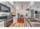 Well-lit kitchen boasts stainless steel appliances and an open layout to the dining area at 6001 Castlegate Dr # A33, Castle Rock, CO 80108