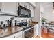 Modern kitchen featuring stainless steel appliances and white cabinets with black hardware at 6001 Castlegate Dr # A33, Castle Rock, CO 80108