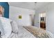 Bright bedroom featuring an en-suite bathroom and large, comfortable bed and pillows at 6001 Castlegate Dr # A33, Castle Rock, CO 80108