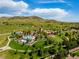 Stunning aerial view of community with pool, clubhouse, landscaping, and scenic mountain backdrop at 2347 S Loveland St, Lakewood, CO 80228