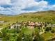 An aerial view shows the community featuring a pool, clubhouse, green spaces and rolling hills at 2347 S Loveland St, Lakewood, CO 80228