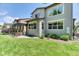 This backyard boasts a spacious lawn, patio with pergola, and manicured landscaping with mature trees at 2347 S Loveland St, Lakewood, CO 80228