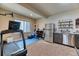 Finished basement space with workout area, refrigerator, and storage at 2347 S Loveland St, Lakewood, CO 80228