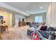 Bright finished basement with a large sectional sofa and a stationary bicycle at 2347 S Loveland St, Lakewood, CO 80228