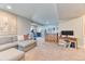 Large, carpeted finished basement featuring a sectional sofa, bar, and exercise equipment at 2347 S Loveland St, Lakewood, CO 80228