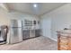 Finished basement with a bar area, stainless steel refrigerator, and storage at 2347 S Loveland St, Lakewood, CO 80228