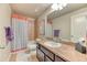Bright bathroom featuring a shower-tub combo and a stylish single sink vanity with dark wood cabinets at 2347 S Loveland St, Lakewood, CO 80228