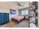 Cozy bedroom featuring carpet, large window, ceiling fan, and a blue dresser at 2347 S Loveland St, Lakewood, CO 80228