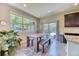 Bright dining area features a large window, hardwood floors, and an adjacent outdoor patio at 2347 S Loveland St, Lakewood, CO 80228