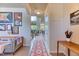 Welcoming hallway featuring a patterned rug and decor, leading to the living area with ample natural light at 2347 S Loveland St, Lakewood, CO 80228